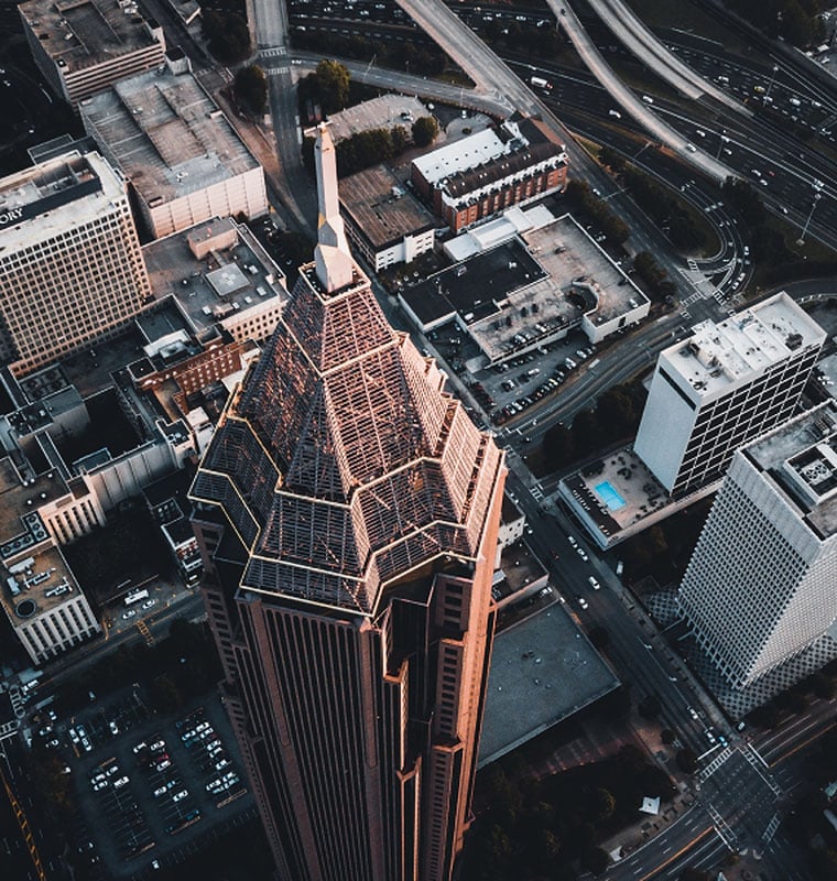Aerial view of tall building in a busy city. 